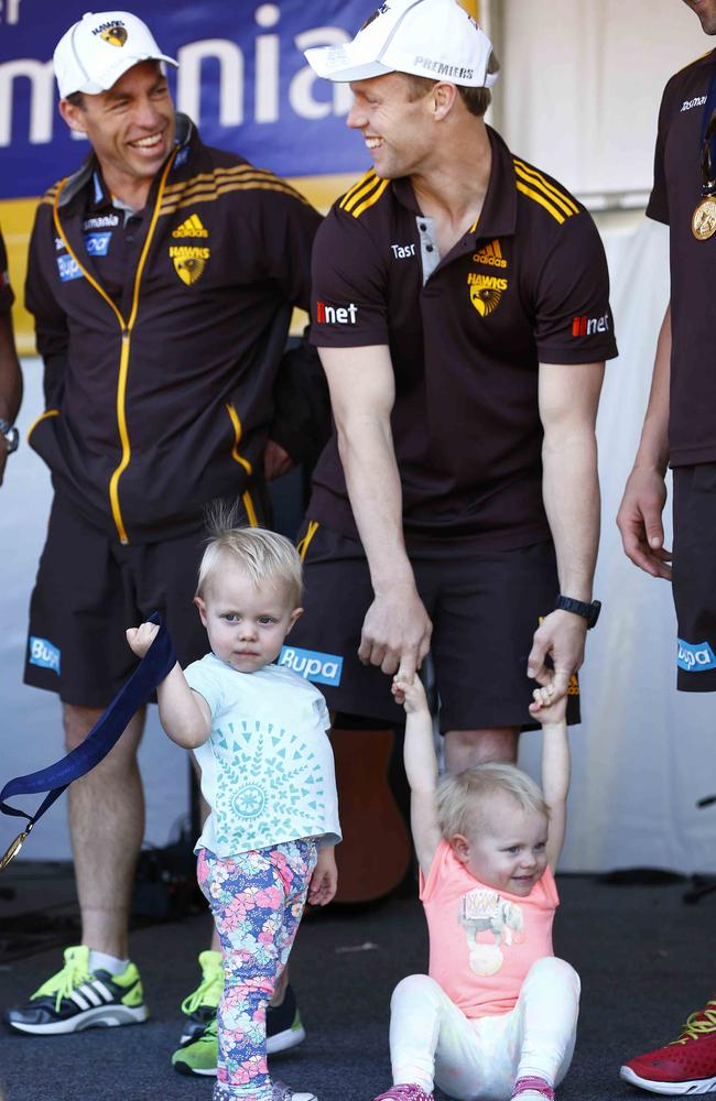 Alastair Clarkson with Sam Mitchell and his daughters Emmerson (orange) and Scarlett (blue) at Hawthorn’s 2013 premiership celebration. Picture: Michael Klein