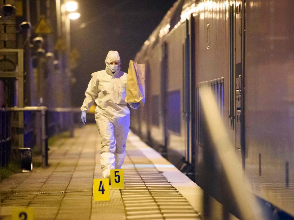 Forensic staff secure evidence on the platform of the train station in a huge police operation. Picture: Gregor Fischer/AFP