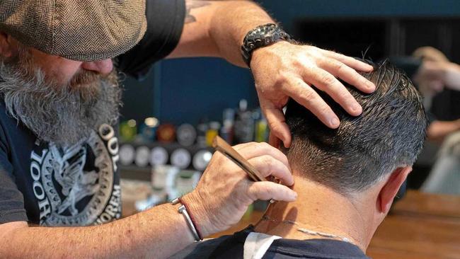 Damian Roche from Houston and Co Barber Shop in Karalee tends to a client. Picture: Contributed