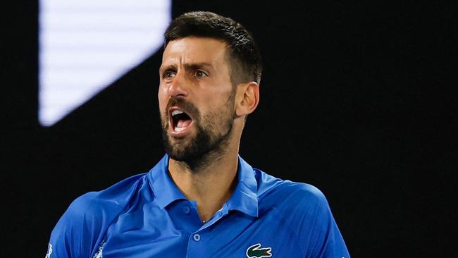 Serbia's Novak Djokovic reacts after a point against Czech Republic's Tomas Machac during their men's singles match on day six of the Australian Open tennis tournament in Melbourne on January 17, 2025. (Photo by Martin KEEP / AFP) / -- IMAGE RESTRICTED TO EDITORIAL USE - STRICTLY NO COMMERCIAL USE --