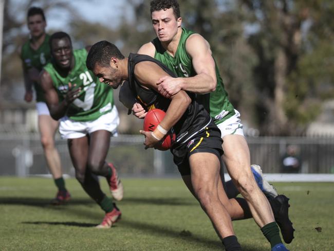 Jake Gasper of City is wrapped up by Alex Cincotta. Picture: Getty Images