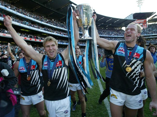 Kane and Chad Cornes celebrate the 2004 grand final win.