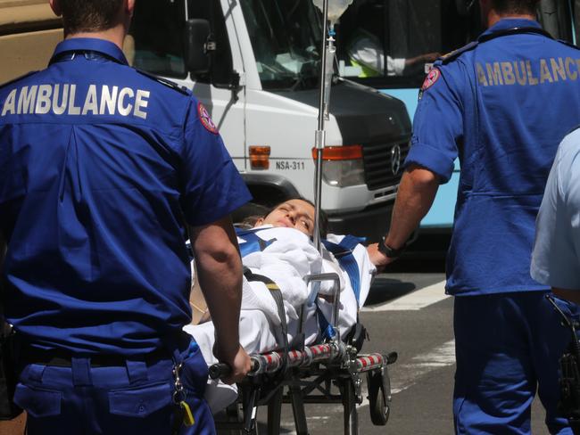 A supporter of Tony Halloun was stretched out of court after collapsing. Picture: Ross Schultz