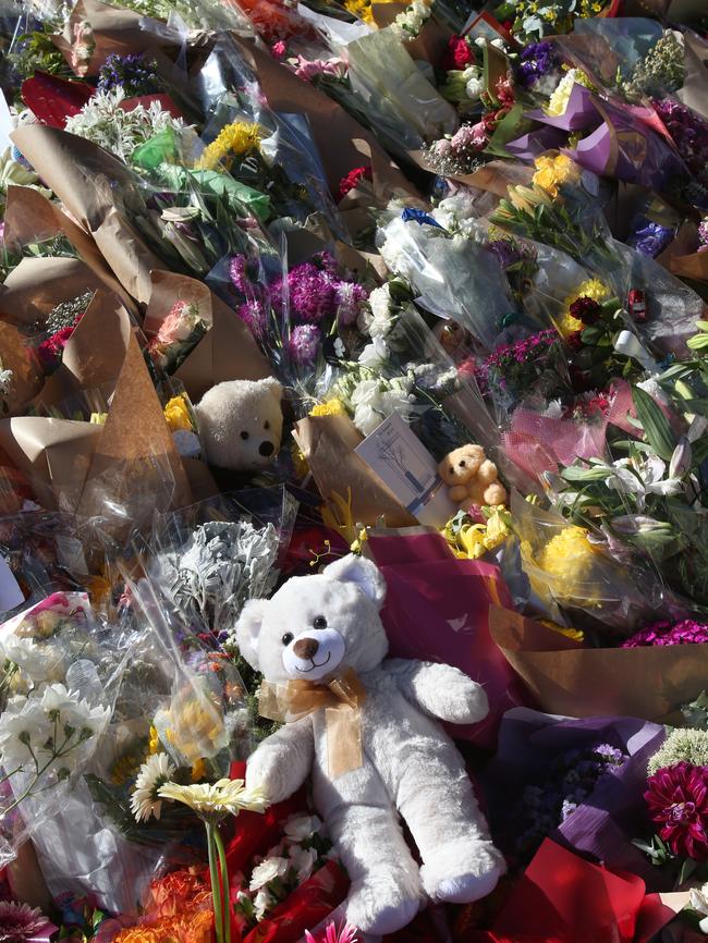 Flowers and teddy bears at a memorial in Bourke St on Sunday evening. Picture: David Crosling