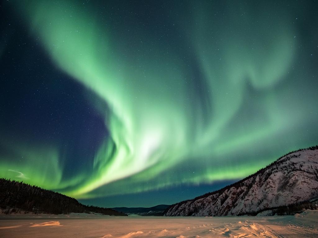 <span>9/20</span><h2>Aurora Borealis, Yukon</h2><p> Thanks to a phenomenon where the sun’s electrically charged particles collide with gases in Earth’s atmosphere to create a glow, parts of Canada are often treated to a display of purple, green, blue and red ribbons streaming across the night sky. The aurora borealis (aka Northern Lights) can be seen in many countries, but Canada’s proximity to the North Pole and particularly dark, clear skies in the Yukon, Nunavut and the Northwest Territories intensify the spectacle.</p>