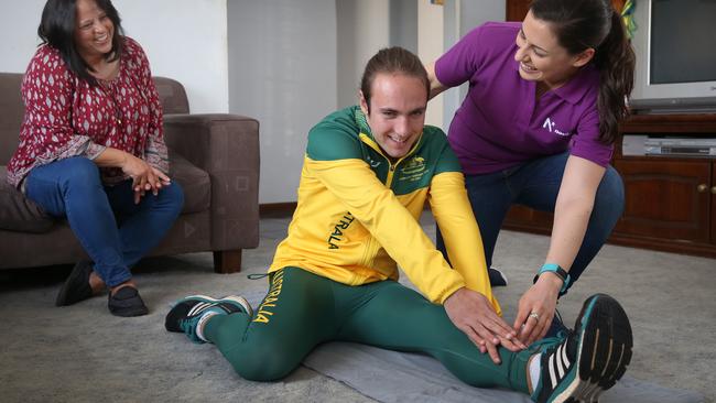 Novita physio Amanda D'Alessandro puts Brayden Davidson through his paces watched by his mum Gail. Picture Dean Martin