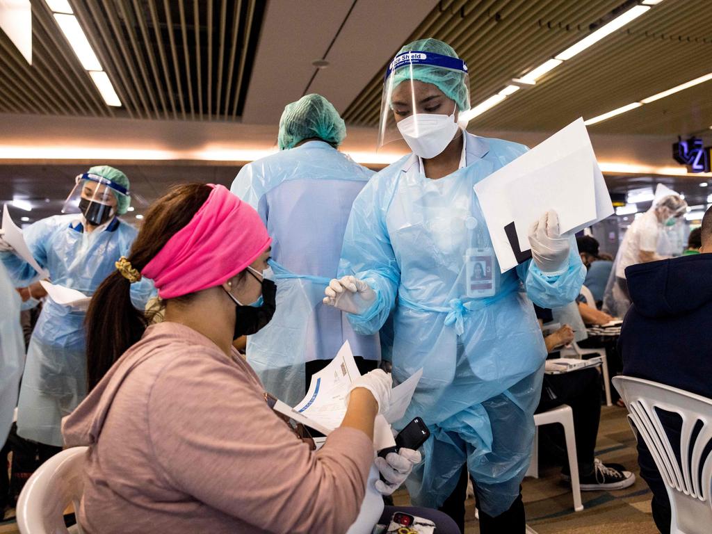 Health staff working at Thailand’s Phuket International Airport as part of the Sandbox scheme. Picture: Jack Taylor/AFP