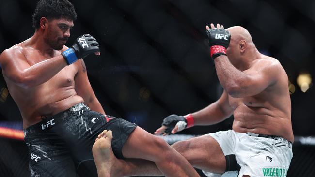 Marcos Rogerio de Lima (right) kicks Junior Tafa’s leg. (Photo by Sean M. Haffey/Getty Images)