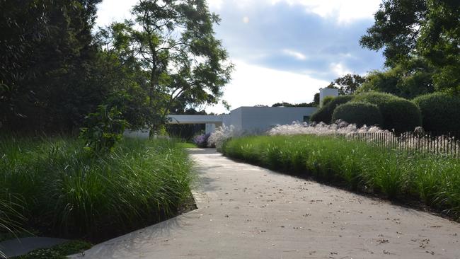 The mid-century design of the house runs into the garden