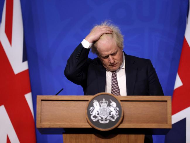 (FILES) In this file photo taken on November 27, 2021 Britain's then prime minister Boris Johnson gestures as he attends a media briefing on the latest Covid-19 update in the Downing Street briefing room in central London. Johnson announced his resignation as an MP on June 9, 2023, accusing a parliamentary probe into the "Partygate" scandal of driving him out. Johnson, 58, said he was stepping down with immediate effect "triggering an immediate by-election" in his marginal seat, which heaps political pressure on his successor Rishi Sunak. (Photo by Hollie Adams / POOL / AFP)