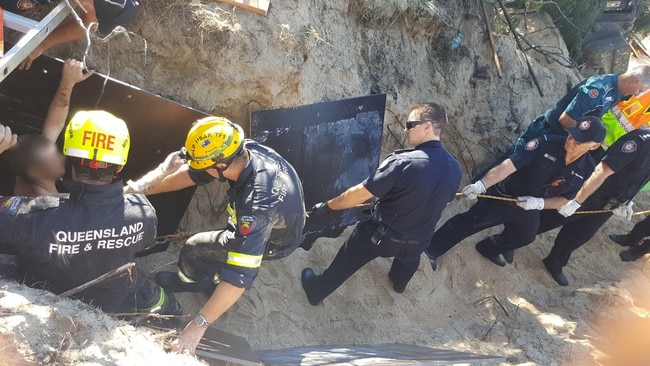 Emergency services work to free the man stuck in the sinkhole. Picture: Queensland Police Service