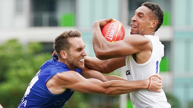 Jamie Macmillan tackles Aiden Bonar during North Melbourne’s intra-club match at Arden Street Oval. Picture: Michael Dodge/AAP