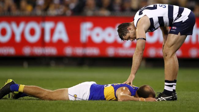 Tom Hawkins checks on Will Schofield of the Eagles.