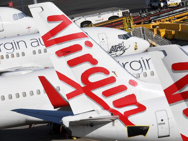 Grounded Virgin Australia planes are seen at Tullamarine Airport in Melbourne, Tuesday, April 21, 2020. Virgin Australia has gone into voluntary administration following financial pressure due to the impact of Coronavirus. (AAP Image/James Ross) NO ARCHIVING