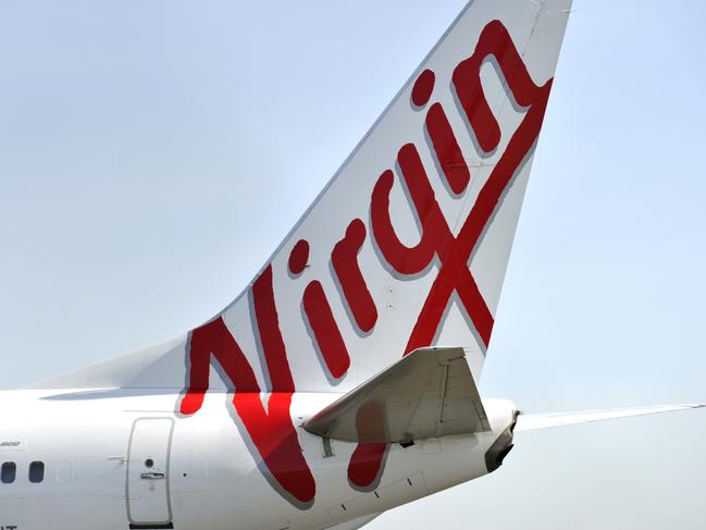 Virgin Australia aircraft seen at Sydney International Airport, Sydney, Friday, Aug. 12, 2016. International air passengers are being warned of potential disruption and delays when union members in the Department of Immigration and Border Protection strike for 24 hours. (AAP Image/Joel Carrett) NO ARCHIVING