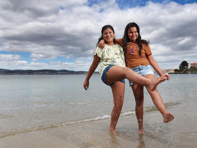 Ariana Rivera, 11, and her cousin, Victoria Aburto, 11, both visiting from Sydney, at Sandy Bay’s Long Beach. Picture: NIKKI DAVIS-JONES