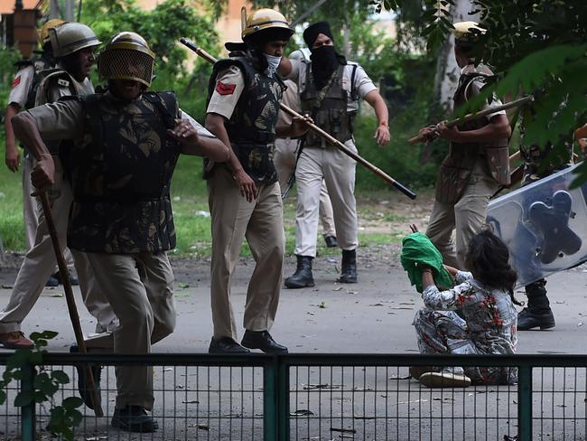 A follower of Indian religious leader Gurmeet Ram Rahim Singh pleads for her safety during clashes in Panchkula. Picture: AFP