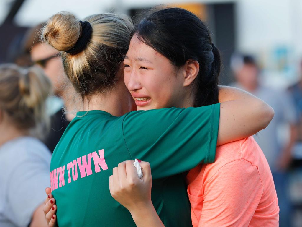 Friends and family comfort one another after the shooting. Picture: Bob Levey/Getty Images