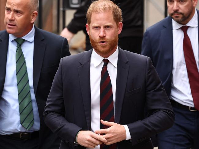 Britain's Prince Harry, Duke of Sussex walks with a security detail as he arrives at the the Royal Courts of Justice, Britain's High Court, in central London, on April 8, 2025 for the second day of his appeal hearing to over the downgrading of his personal security during visits in Britain. Prince Harry's lawyer outlined in court threats made against him, including calls for his murder, as King Charles's youngest son appealed on April 8, 2025 against an 