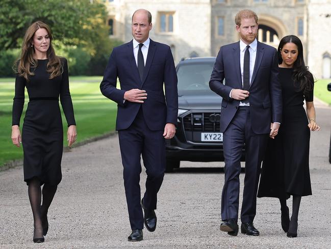 WINDSOR, ENGLAND - SEPTEMBER 10: Catherine, Princess of Wales, Prince William, Prince of Wales, Prince Harry, Duke of Sussex, and Meghan, Duchess of Sussex on the long Walk at Windsor Castle arrive to view flowers and tributes to HM Queen Elizabeth on September 10, 2022 in Windsor, England. Crowds have gathered and tributes left at the gates of Windsor Castle to Queen Elizabeth II, who died at Balmoral Castle on 8 September, 2022. (Photo by Chris Jackson/Getty Images)