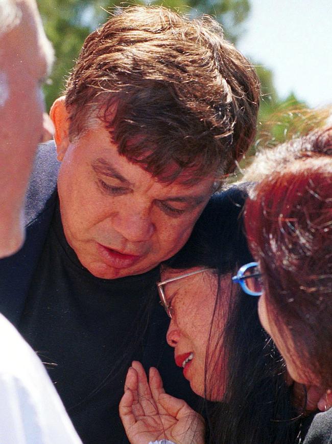 Arthur Beetson consoles Laurie's partner Eva Tsang. Picture: Ron Hutchings