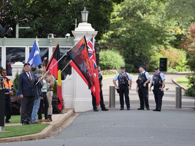 A small group of protesters waited outside Government House for the Prime Minister’s arrival. Picture: Toby Zerna