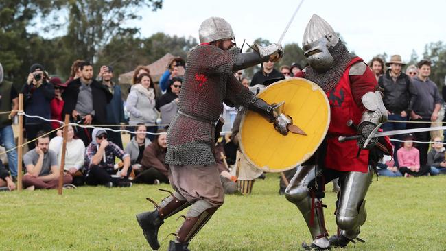 Men battle it out with a sword fight at the Hawkesbury Showground Winterfest Medieval Festival on Saturday, July 7, 2018. The festival drew a large crowd from the Hawkesbury area who came for the food, folk music and fun. (AAP Image/David Swift)