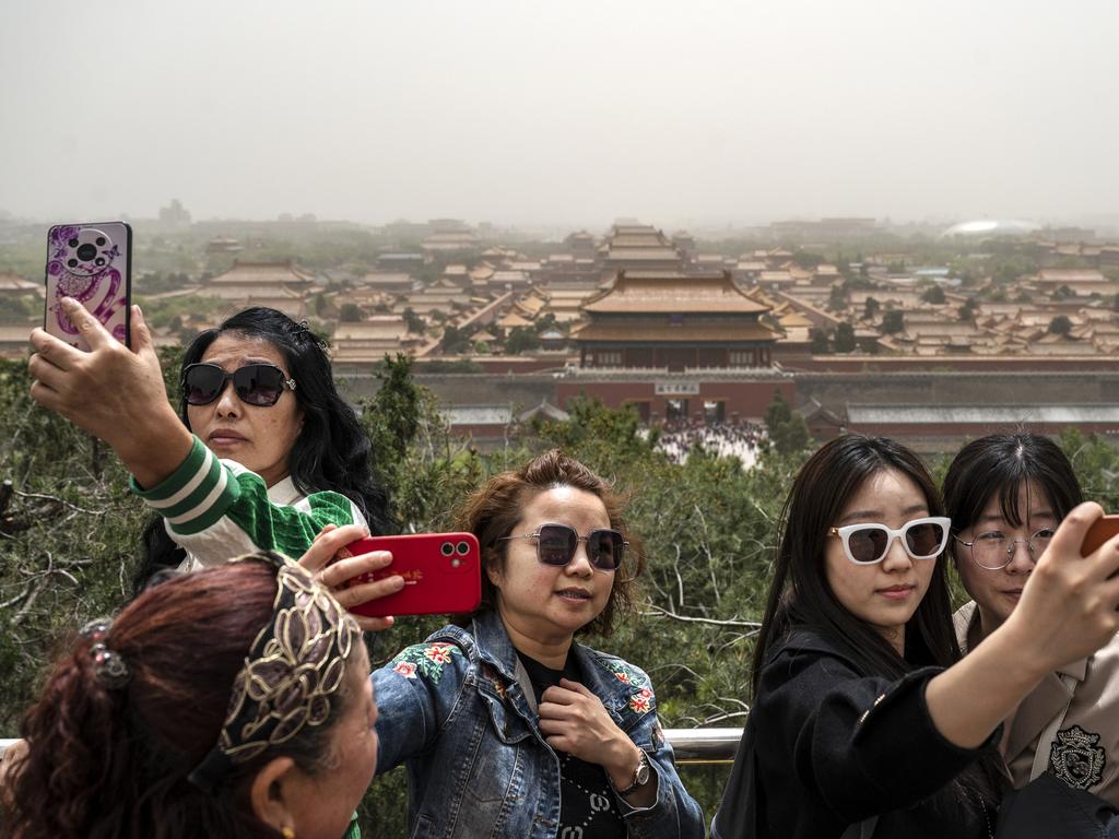 Visitors take photos as the Forbidden City and Palace Museum in Beijing, China last month. Picture: Kevin Frayer/Getty Images