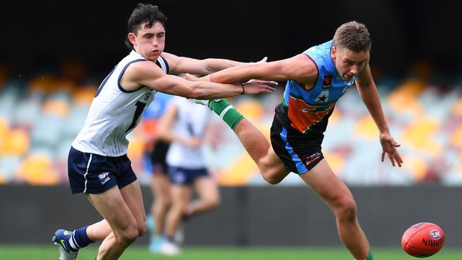 Marlin Corbett of Allies is tackled by Jonti Schuback of Vic Country during the U18 AFL Boys Championship match. (Photo by Albert Perez