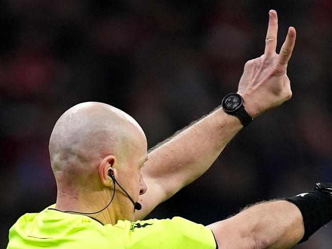 MADRID, SPAIN - MARCH 12: Referee Szymon Marciniak gestures as the second penalty kick for Atletico de Madrid, taken by Julian Alvarez (not pictured), is ruled out following a VAR Review for an improper kick during the UEFA Champions League 2024/25 Round of 16 second leg match between Atletico de Madrid and Real Madrid C.F. at Estadio Metropolitano on March 12, 2025 in Madrid, Spain. (Photo by Angel Martinez/Getty Images)