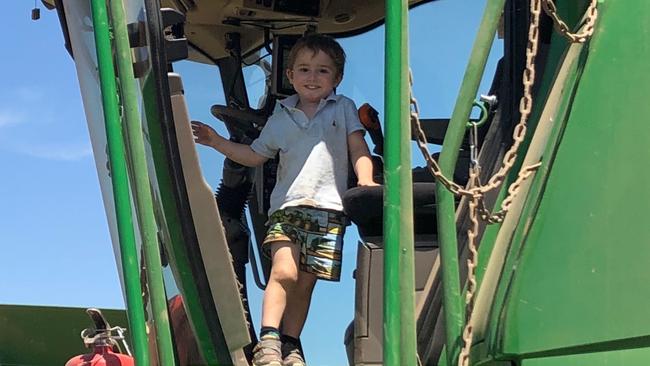 Young Thom Siddins, 3, is already loves helping his dad out on the farm. Picture: contributed