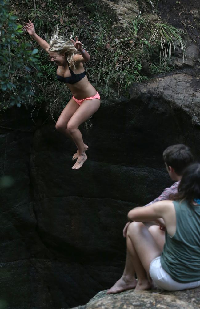 Elyse Karlisle jumps off the rocks at Killarney Glen. Photo: Regi Varghese.