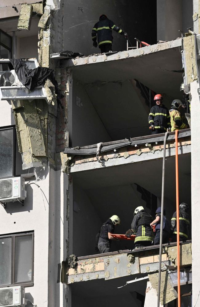 Rescuers evacuate a person from a damaged residential building hit by Russian missiles in Kyiv. Picture: AFP