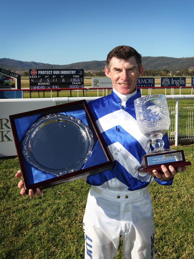 RT with trophies presented to him to mark his 4000 race wins.