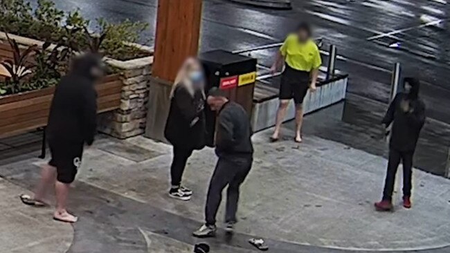 Detectives investigating the theft of an ATM at Cameron Park wish to speak with two men shown here – the man about to pick up his beanie and the other in a hoodie and mask. Picture: NSW Police