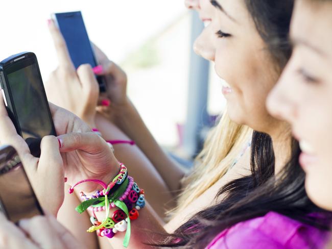 Townsville Families: generic pic of three teen girls chatting with their smartphones from ThinkStock