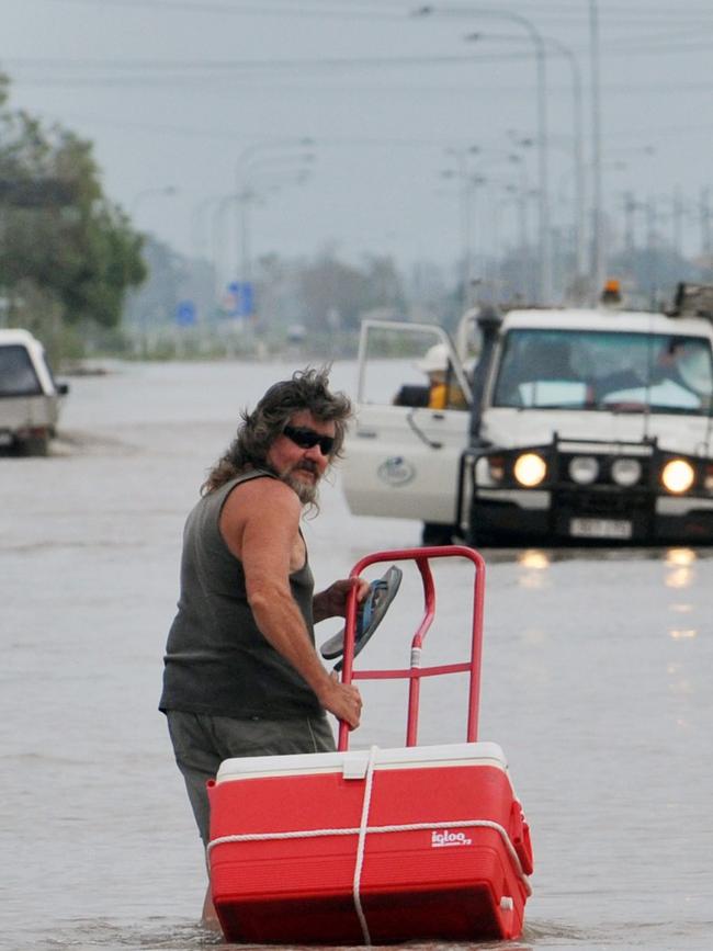Ten year anniversary of Cyclone Yasi. Severe Cyclone Yasi 2011. In the aftermath Ingham floods. A resident wades along Townsville Road. Picture: Evan Morgan