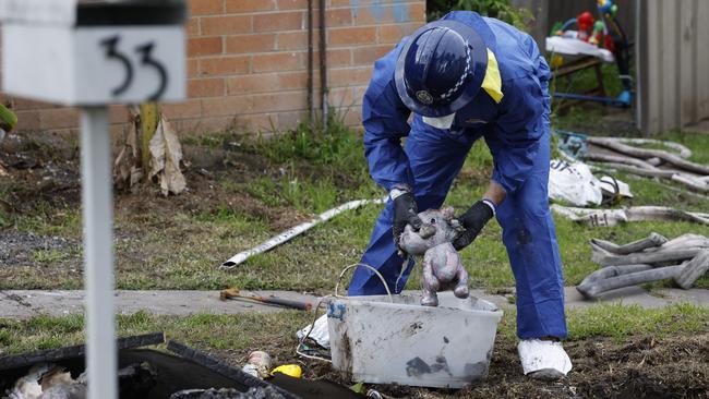 A forensics police officer at the scene of the horrific house fire in Lalor Park. Picture: Richard Dobson