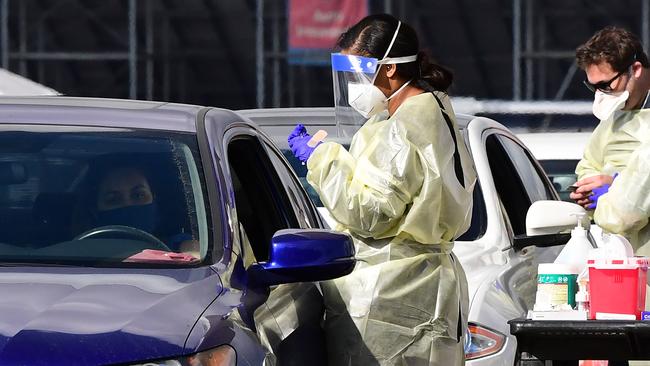 A woman sits in her car as a healthcare worker gets ready to inoculate her with COVID-19 vaccine at the Fairplex in Pomona, California. Picture: AFP