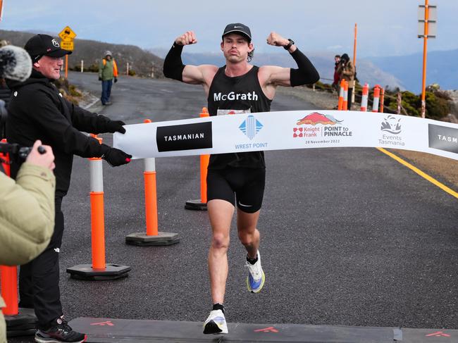 Winner in the men's event for the 2022 Point to Pinnacle James Hansen crosses the line in 1:25:35. Picture: Robert Groom/ RaceAtlas