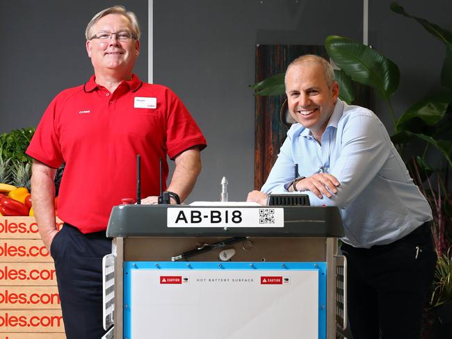 Coles CEO Steven Cain, Ocado CEO Tim Steiner and the new Ocado bot, which will be used by Coles to streamline their online deliveries. Picture: Aaron Francis