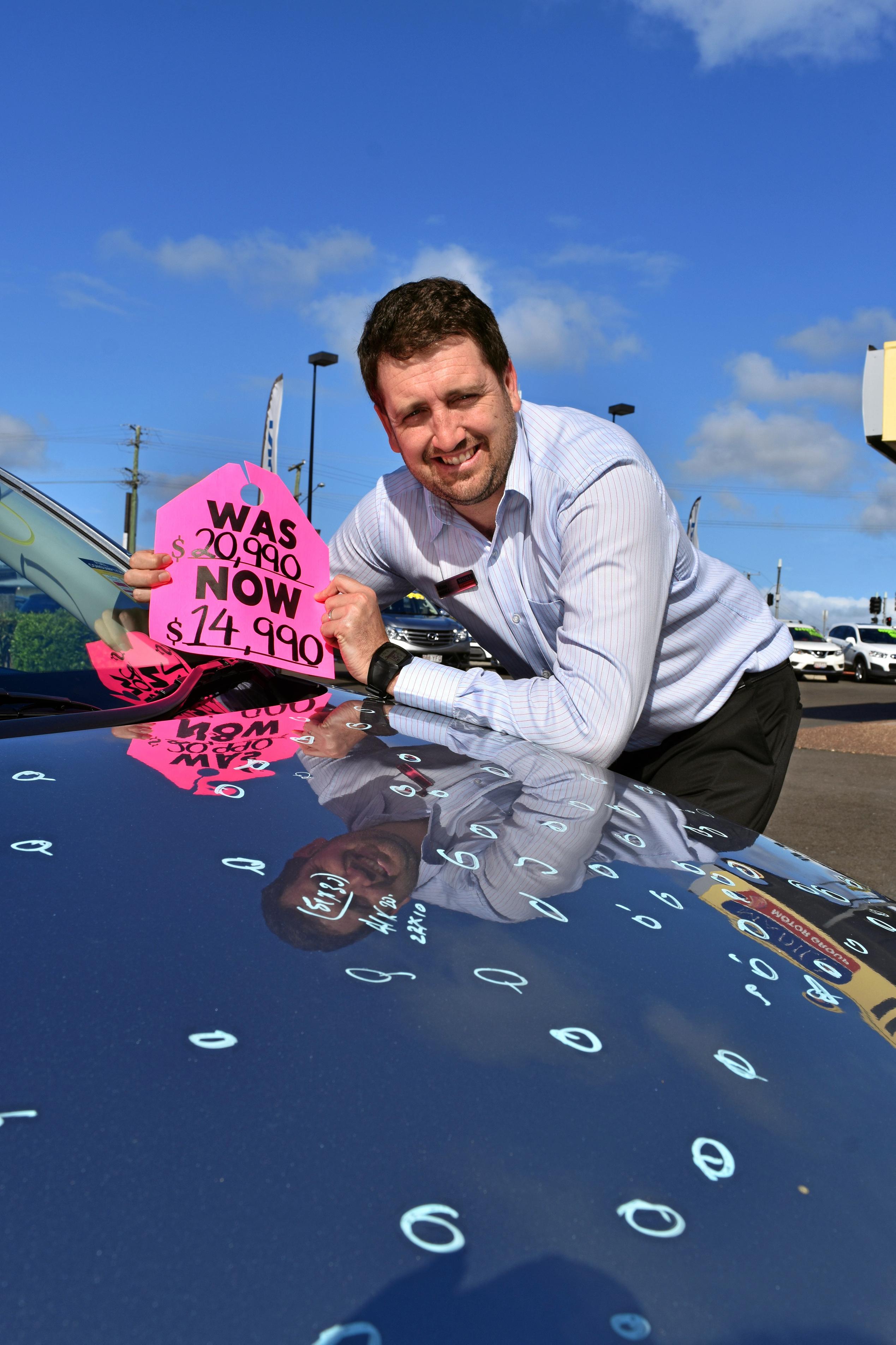 Adam Madill has had to drastically reduce the prices of cars in the lot because of hail damage. Picture: DONNA JONES