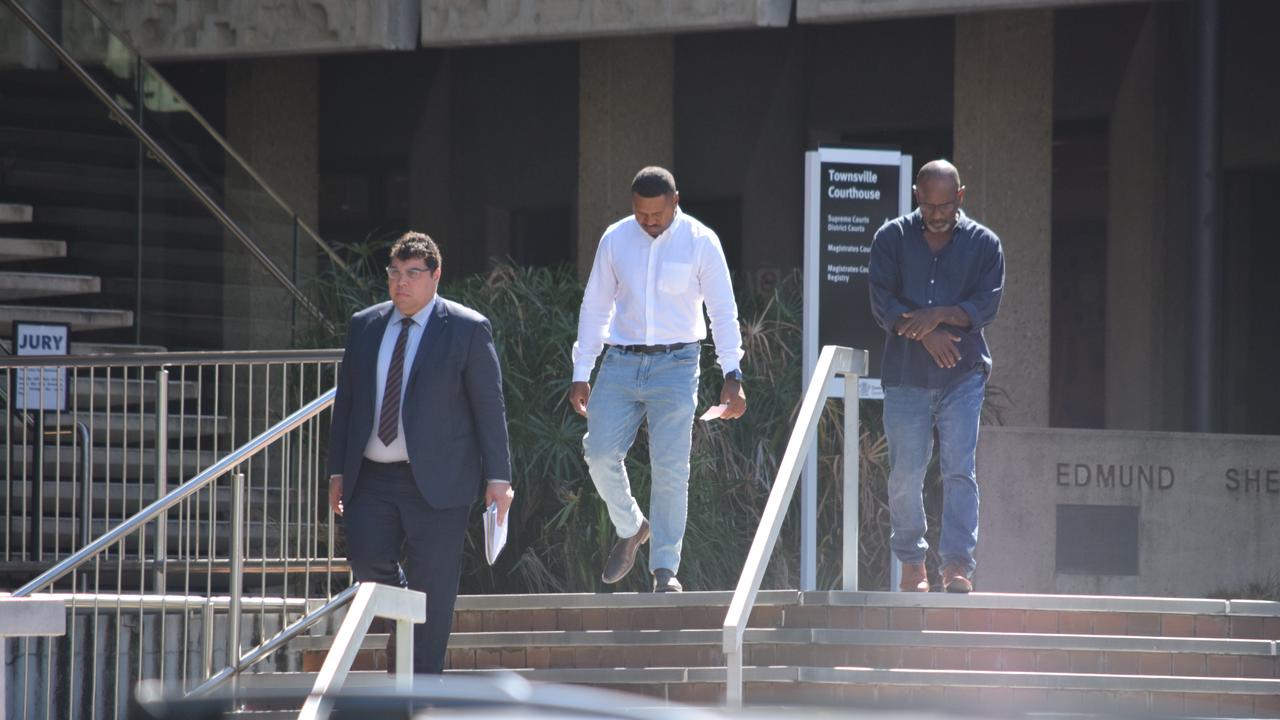 Sean Ladi Suk (centre), 22, leaves court after being sentenced for seven counts of stalking.
