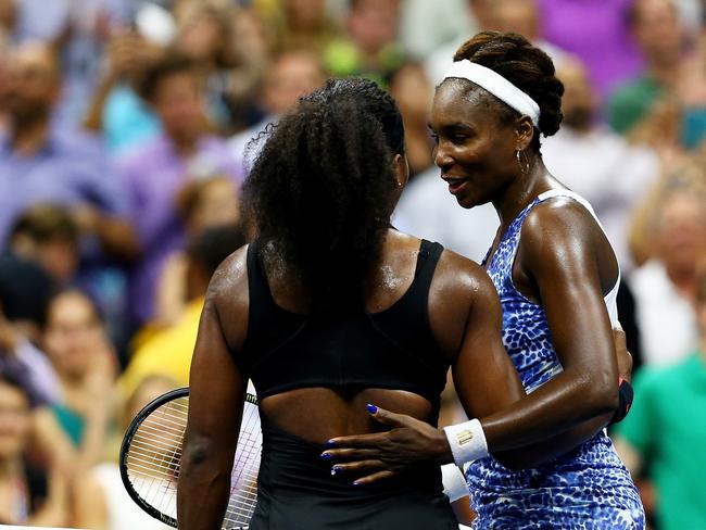 Serena Williams (L) of the United States hugs Venus Williams of the United States after defeating her during their Women's Singles Quarter-finals match.