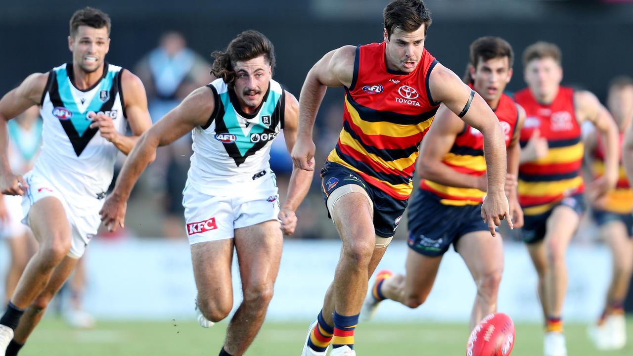 Darcy Fogarty in a foot race with Port Adelaide’s Lachie Jones on Saturday. Picture: Sarah Reed/AFL Photos