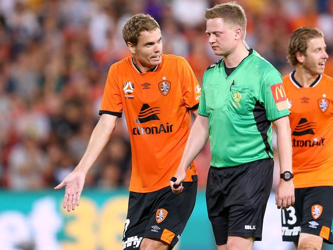 Thomas Kristensen of the Roar (left) pleads with referee Adam Fielding during the Round 8 A-League match between Brisbane Roar FC and Melbourne Victory at Suncorp Stadium in Brisbane, Friday, December 14, 2018. (AAP Image/Jono Searle) NO ARCHIVING, EDITORIAL USE ONLY