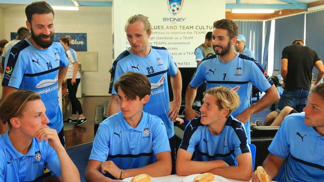 Sydney FC players (l-r) Alex Brosque, Rhyan Grant and Michael Zullo mix with members of the under-18 squad as part of a bonding session after training at Macquarie Park.