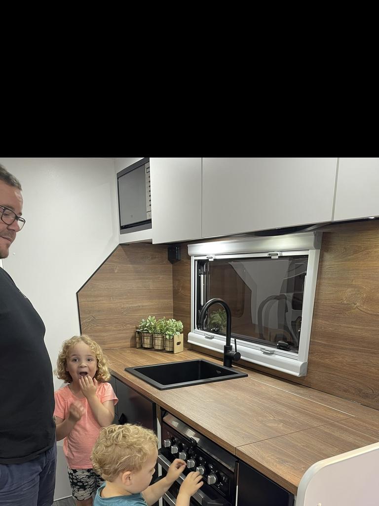 Ms Logan’s husband and kids checking out a Tango Caravan.