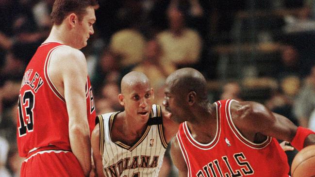 Longley puts a block of Indiana Pacers ace Reggie Miller.