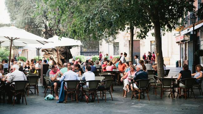 Clicking your fingers might be a bit much as a tourist, but putting your hand in the air is perfectly acceptable.